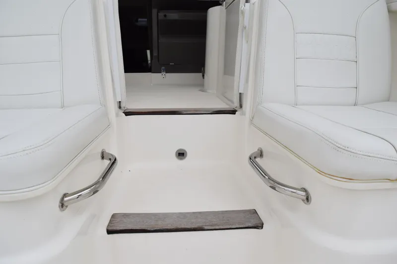 Slide: The Image of 2022 Pursuit OS 355 Offshore boat interior with white seating and stainless steel handles. - 160