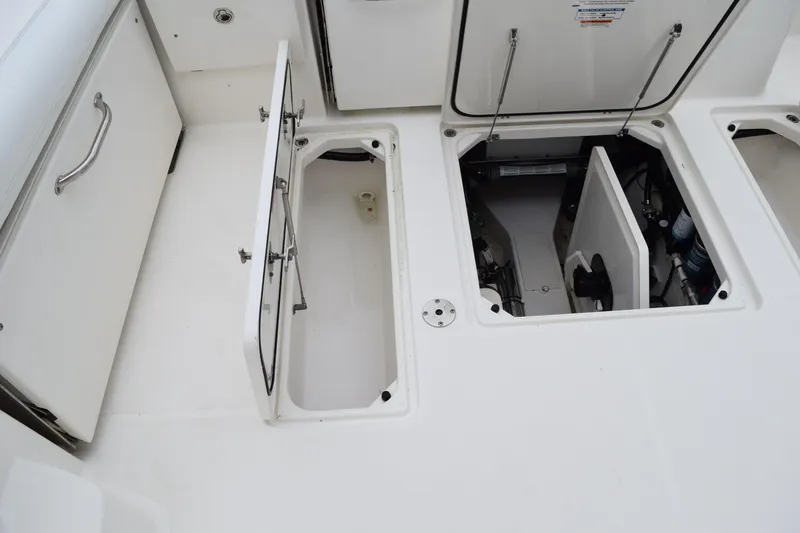 Slide: The Image of 2022 Pursuit OS 355 Offshore boat storage compartments and access hatches. - 143