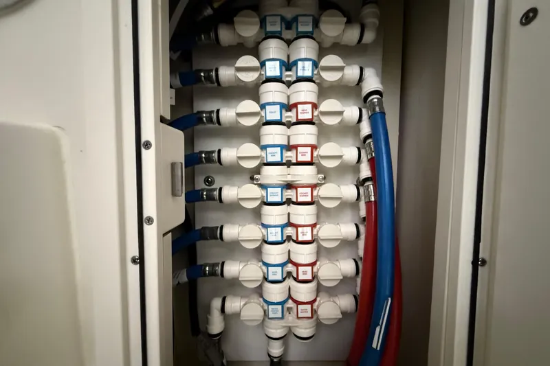 Slide: The Image of Plumbing system in 2022 Pursuit OS 355 Offshore boat, featuring labeled pipes and connectors. - 16