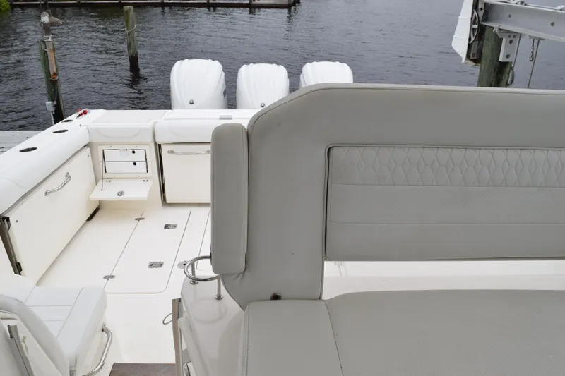 Slide: The Image of 2022 Pursuit OS 355 Offshore boat interior with seating and storage compartments. - 230