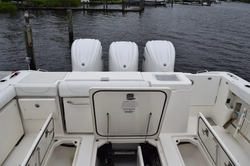 Slide: The Image of 2022 Pursuit OS 355 Offshore boat with triple outboard engines at dock. - 146