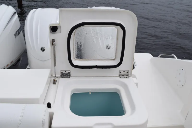 Slide: The Image of 2022 Pursuit OS 355 Offshore boat with open storage compartment and Yamaha engines. - 55