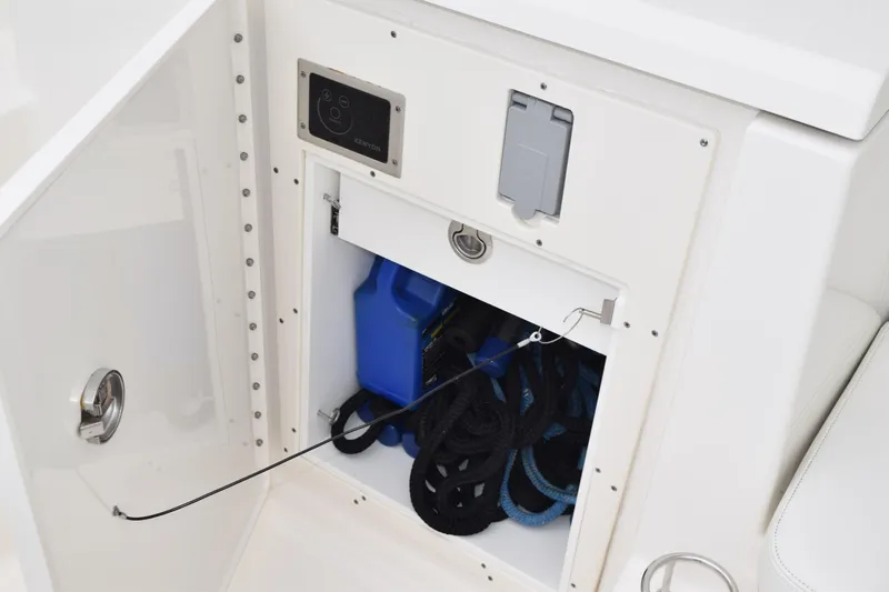 Slide: The Image of Storage compartment on 2022 Pursuit OS 355 Offshore boat with ropes and blue container. - 38