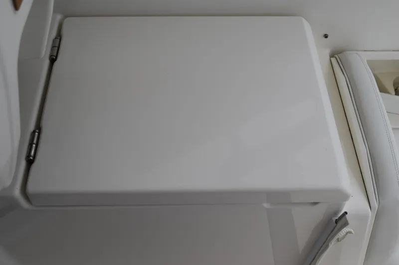 Slide: The Image of 2022 Pursuit OS 355 Offshore boat interior detail with white hinged compartment. - 183
