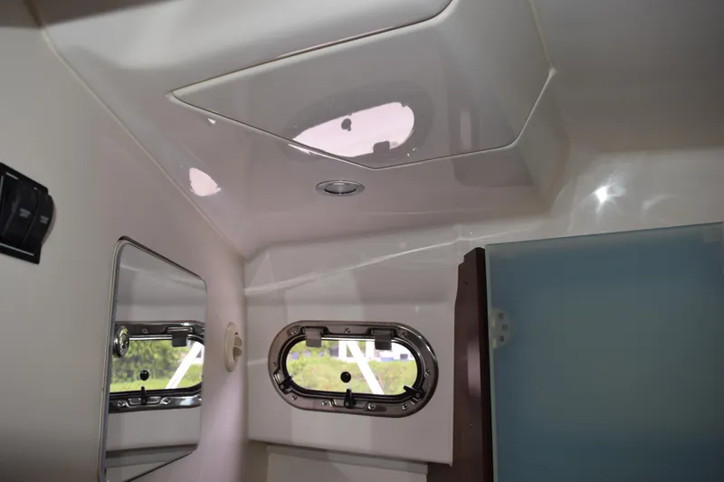 Slide: The Image of Interior of 2022 Pursuit OS 355 Offshore boat, featuring a window and mirror. - 378