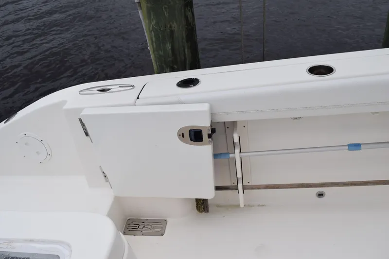 Slide: The Image of 2022 Pursuit OS 355 Offshore boat deck with storage compartment and rod holder. - 105