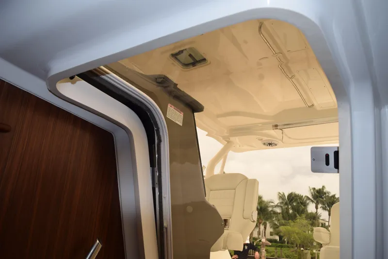 Slide: The Image of 2022 Pursuit OS 355 Offshore boat interior with seating and open cabin door. - 354