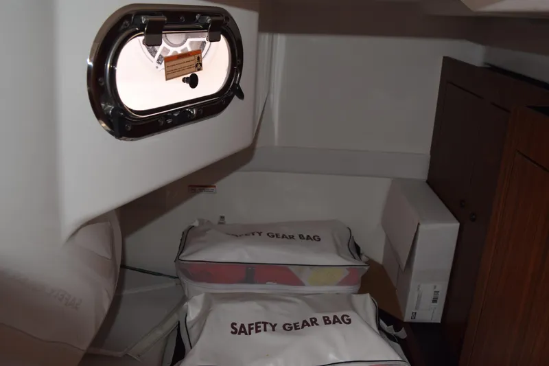 Slide: The Image of Interior of 2022 Pursuit OS 355 Offshore with safety gear bags and porthole. - 381