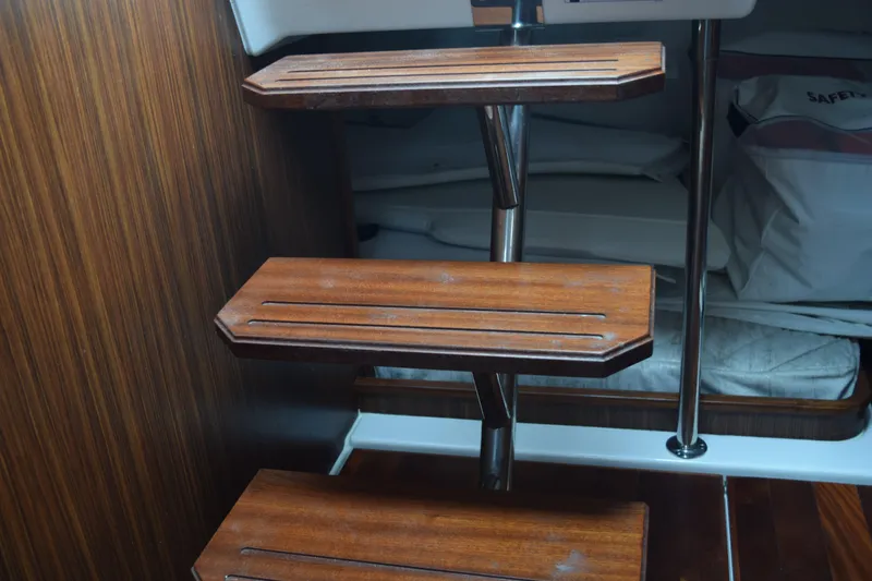 Slide: The Image of Wooden interior stairs on a 2022 Pursuit OS 355 Offshore boat. - 345
