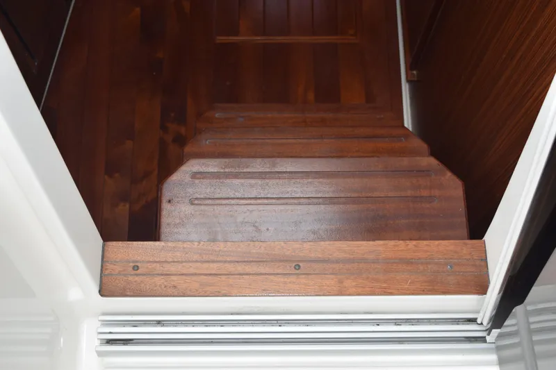 Slide: The Image of Wooden steps inside a 2022 Pursuit OS 355 Offshore boat, showcasing elegant craftsmanship. - 332