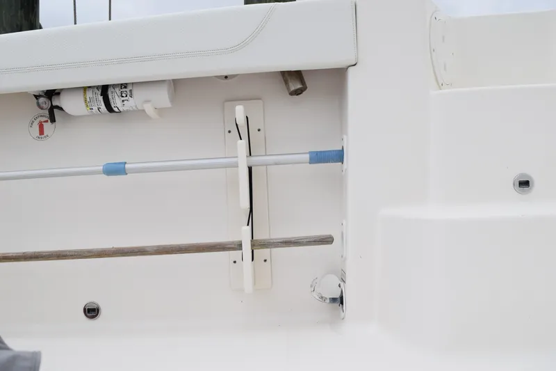Slide: The Image of 2022 Pursuit OS 355 Offshore boat interior with safety equipment and storage features. - 118
