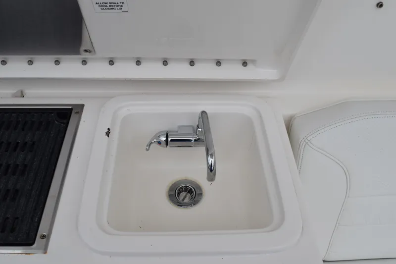 Slide: The Image of 2022 Pursuit OS 355 Offshore boat sink and grill area detail. - 195