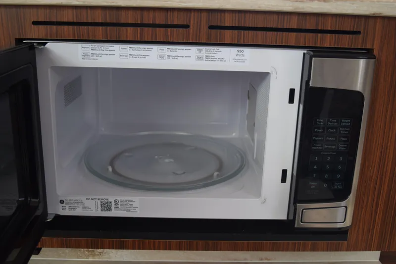 Slide: The Image of Open microwave in 2022 Pursuit OS 355 Offshore boat kitchen. - 393