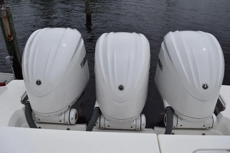Slide: The Image of Triple Yamaha outboard engines on a 2022 Pursuit OS 355 Offshore boat. - 92