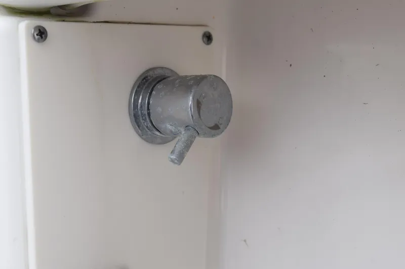 Slide: The Image of Close-up of a metal knob on a 2022 Pursuit OS 355 Offshore boat. - 113