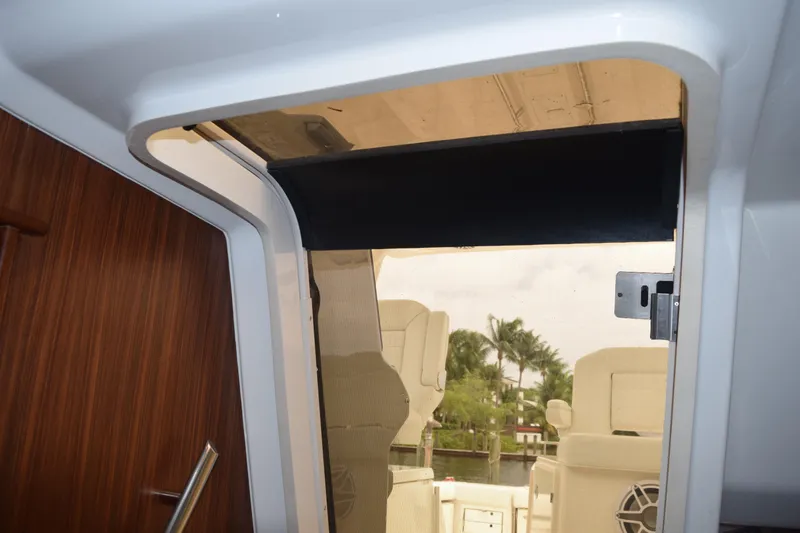 Slide: The Image of 2022 Pursuit OS 355 Offshore cabin entrance with wooden door and outdoor seating view. - 365