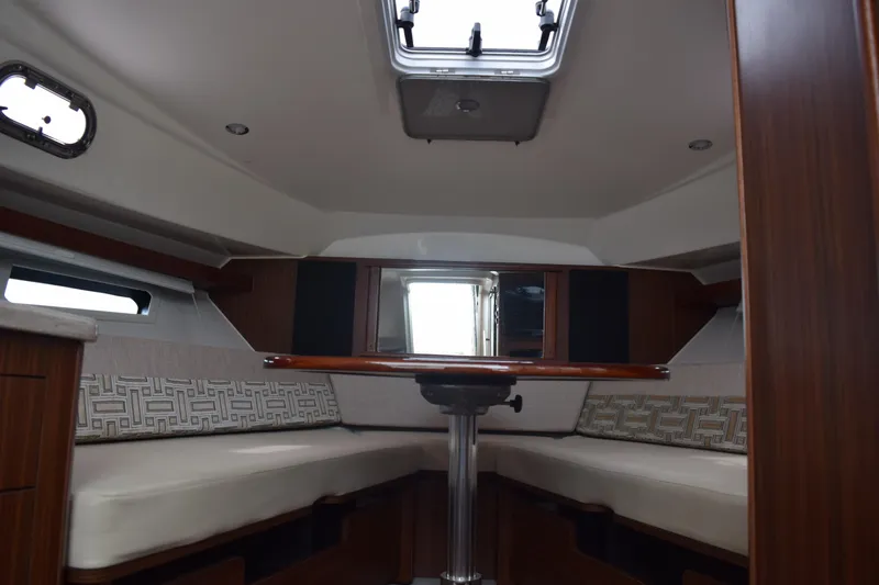 Slide: The Image of 2022 Pursuit OS 355 Offshore cabin interior with seating and table. - 416