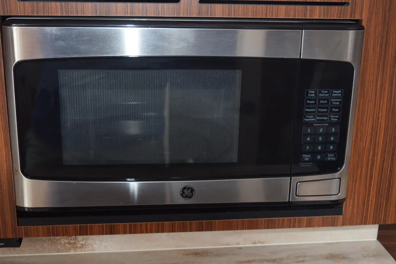Slide: The Image of Stainless steel GE microwave in 2022 Pursuit OS 355 Offshore boat kitchen. - 386