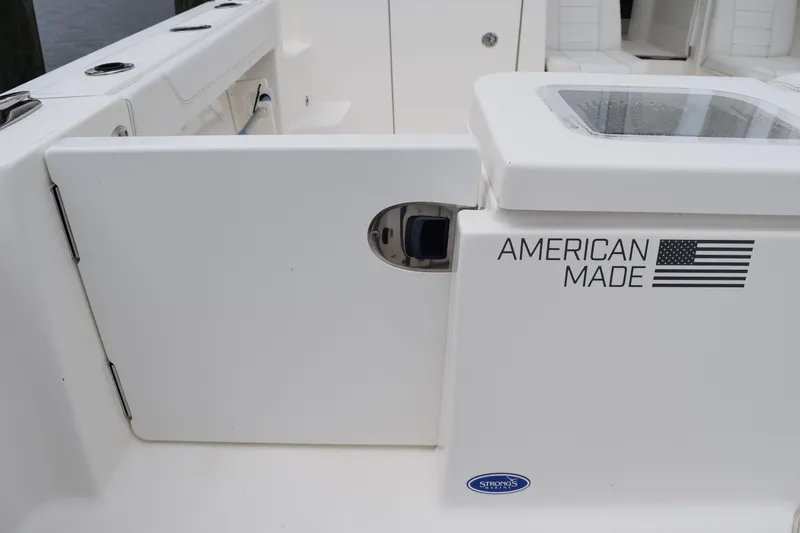 Slide: The Image of 2022 Pursuit OS 355 Offshore boat interior with "American Made" label and flag. - 75