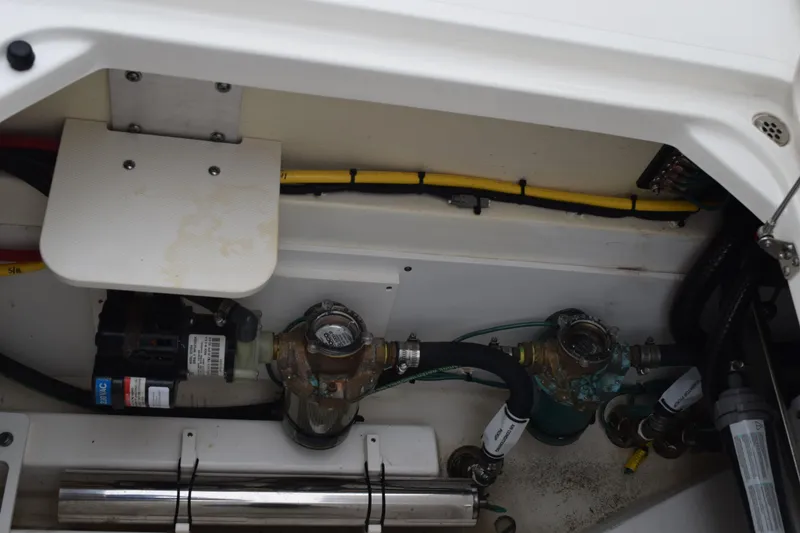 Slide: The Image of 2022 Pursuit OS 355 Offshore engine compartment with wiring and mechanical components. - 133