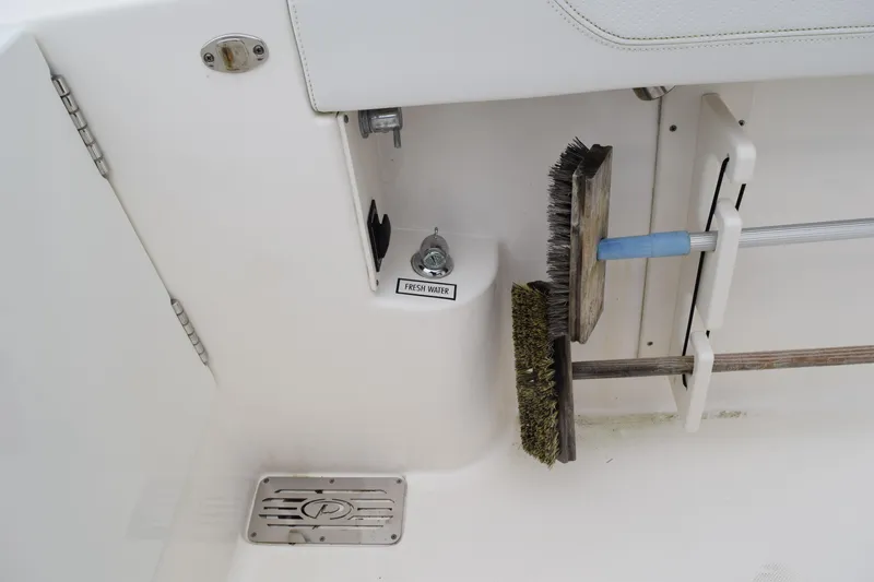 Slide: The Image of 2022 Pursuit OS 355 Offshore boat deck with cleaning brushes and fresh water outlet. - 108