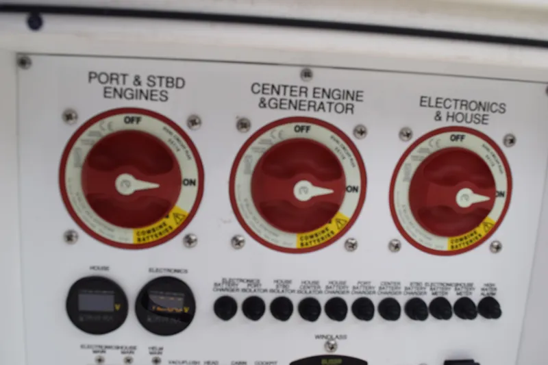 Slide: The Image of Control panel of a 2022 Pursuit OS 355 Offshore boat, featuring engine and electronics switches. - 168