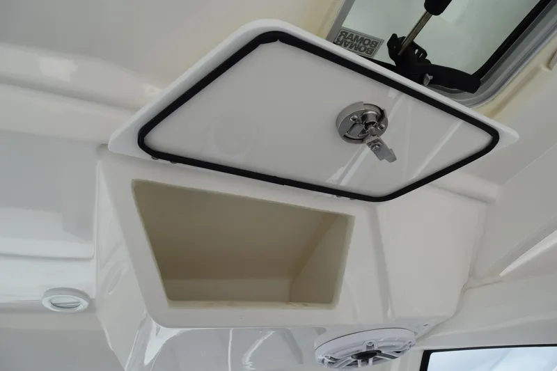 Slide: The Image of 2022 Pursuit OS 355 Offshore storage compartment with secure latch and speaker. - 222