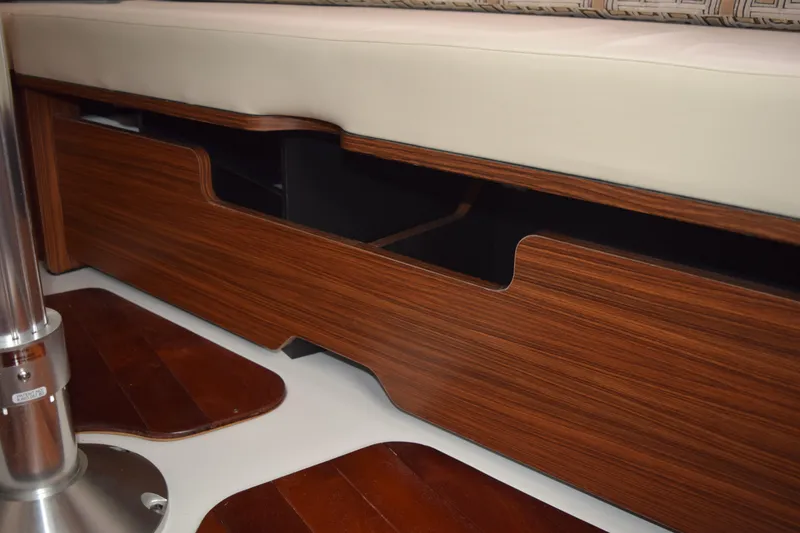 Slide: The Image of 2022 Pursuit OS 355 Offshore interior with wooden storage and cushioned seating. - 439