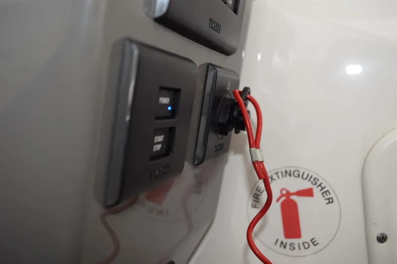 Slide: The Image of Control panel of 2022 Pursuit OS 355 Offshore boat with fire extinguisher sign. - 271