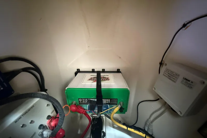 Slide: The Image of Battery compartment of 2022 Pursuit OS 355 Offshore boat with wiring and components. - 14