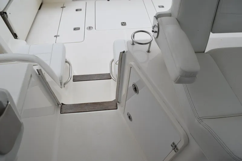 Slide: The Image of 2022 Pursuit OS 355 Offshore boat interior with white seating and storage compartments. - 173