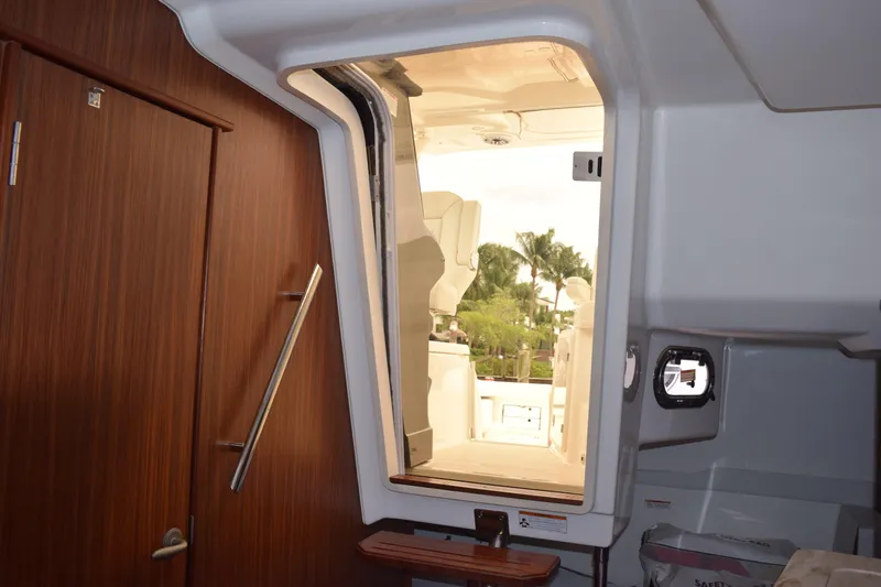 Slide: The Image of Interior view of 2022 Pursuit OS 355 Offshore boat, showing cabin door and seating area. - 356