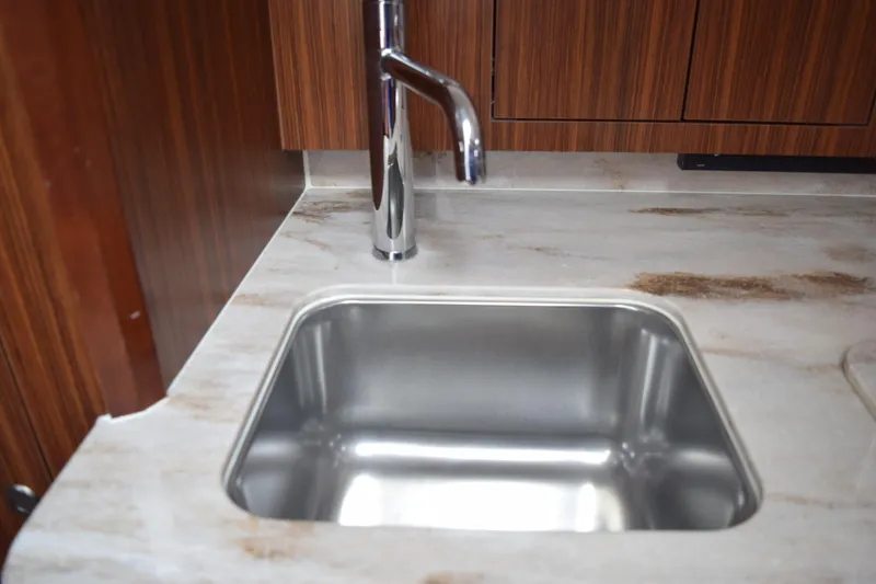 Slide: The Image of Stainless steel sink in 2022 Pursuit OS 355 Offshore boat kitchen. - 431