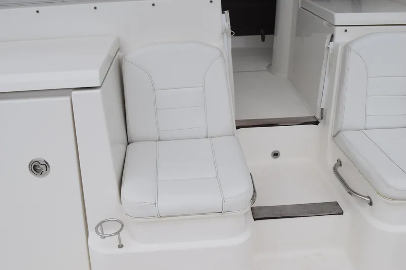 Slide: The Image of 2022 Pursuit OS 355 Offshore boat interior seating with white upholstery. - 33
