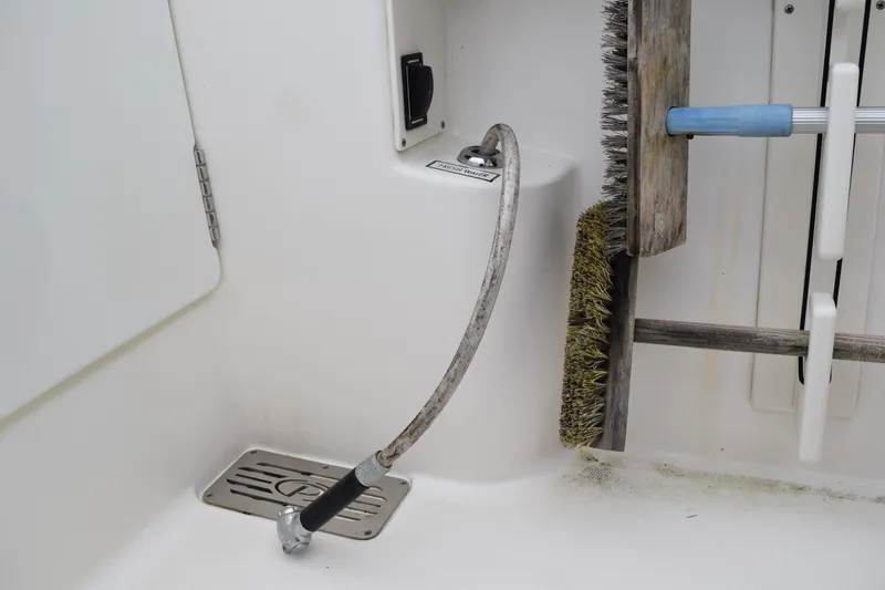 Slide: The Image of 2022 Pursuit OS 355 Offshore boat deck with cleaning tools and hose. - 114