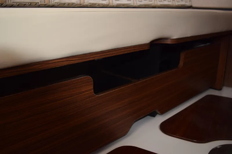 Slide: The Image of 2022 Pursuit OS 355 Offshore interior with wooden storage compartment and cushioned seating. - 440