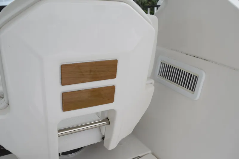 Slide: The Image of 2022 Pursuit OS 355 Offshore boat interior with wooden accents and vent detail. - 175