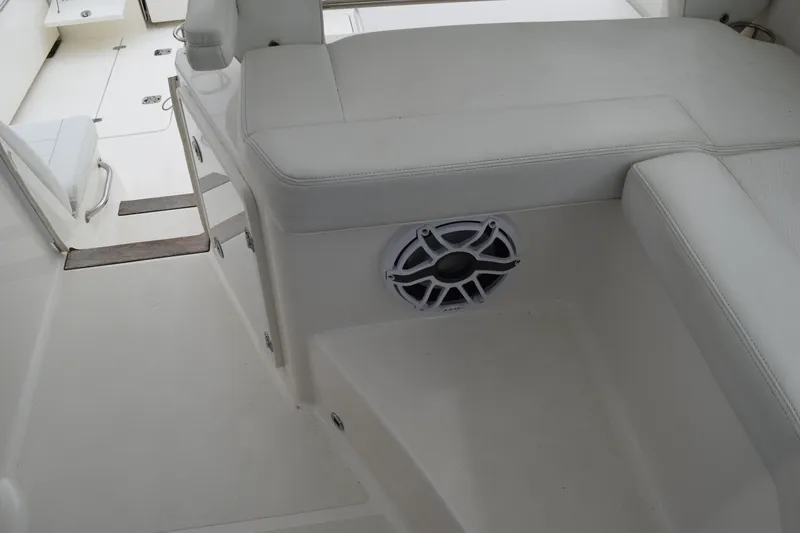 Slide: The Image of 2022 Pursuit OS 355 Offshore boat interior with white seating and speaker. - 228