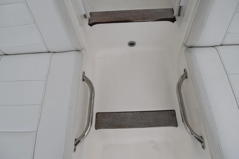 Slide: The Image of 2022 Pursuit OS 355 Offshore boat interior with white seating and metal handles. - 161
