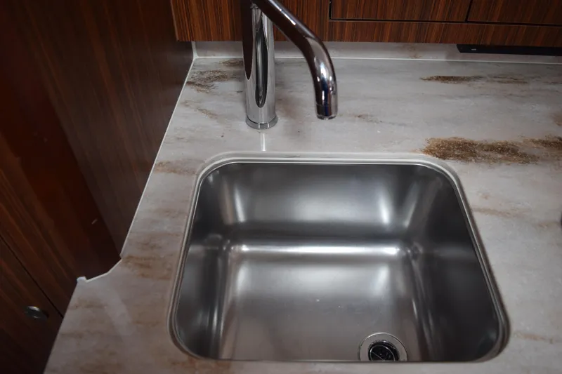 Slide: The Image of Stainless steel sink and faucet in 2022 Pursuit OS 355 Offshore boat kitchen. - 432
