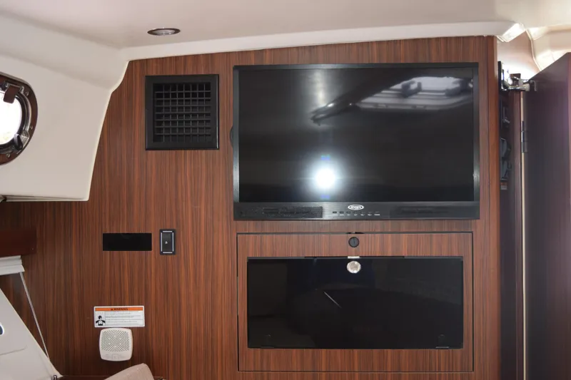 Slide: The Image of Interior of 2022 Pursuit OS 355 Offshore with mounted TV and wood paneling. - 397