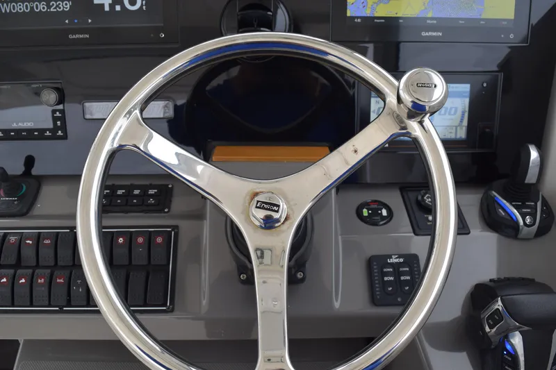 Slide: The Image of Steering wheel and controls of 2022 Pursuit OS 355 Offshore boat cockpit. - 298