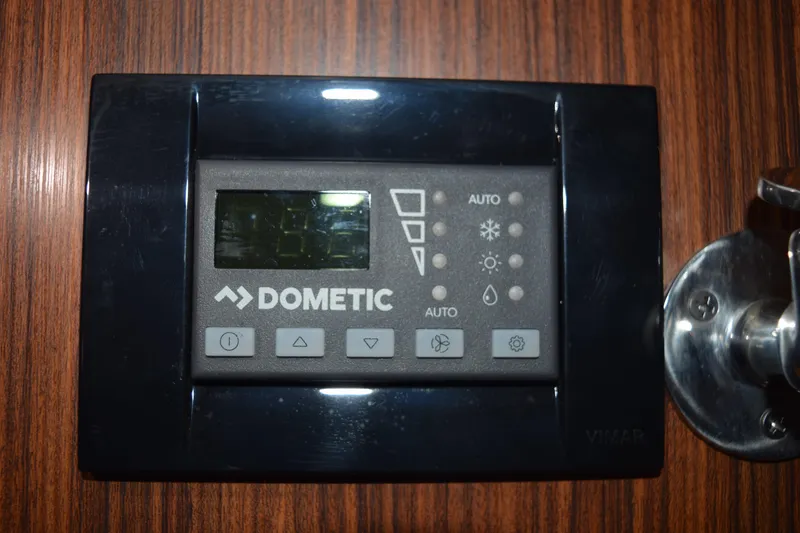 Slide: The Image of Dometic control panel on 2022 Pursuit OS 355 Offshore boat, mounted on wood panel. - 375