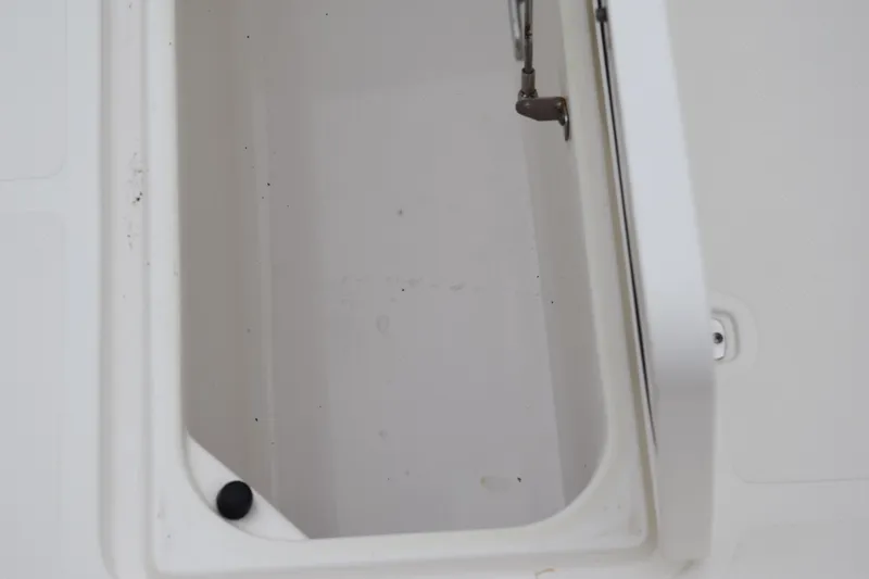 Slide: The Image of Open storage compartment on 2022 Pursuit OS 355 Offshore boat. - 125