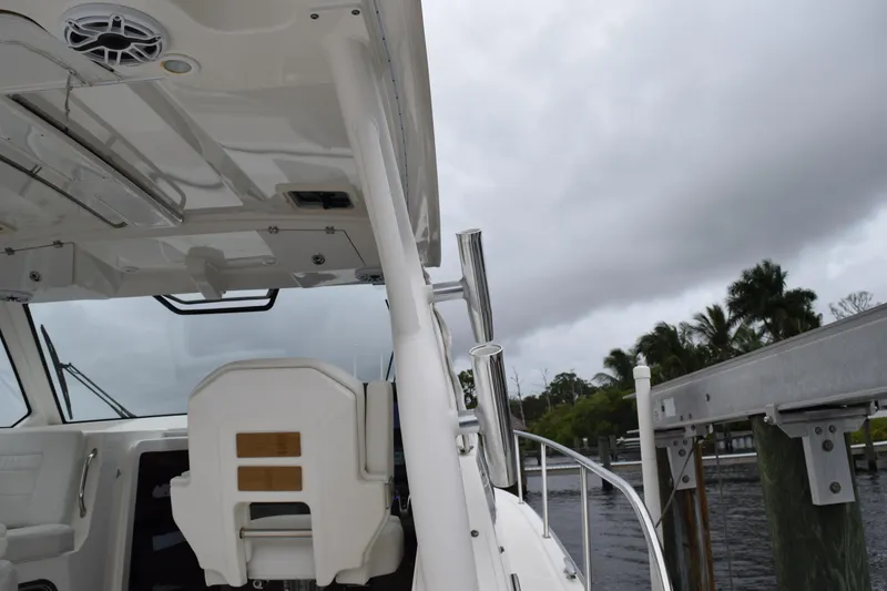 Slide: The Image of 2022 Pursuit OS 355 Offshore boat interior with overcast sky and dock view. - 156