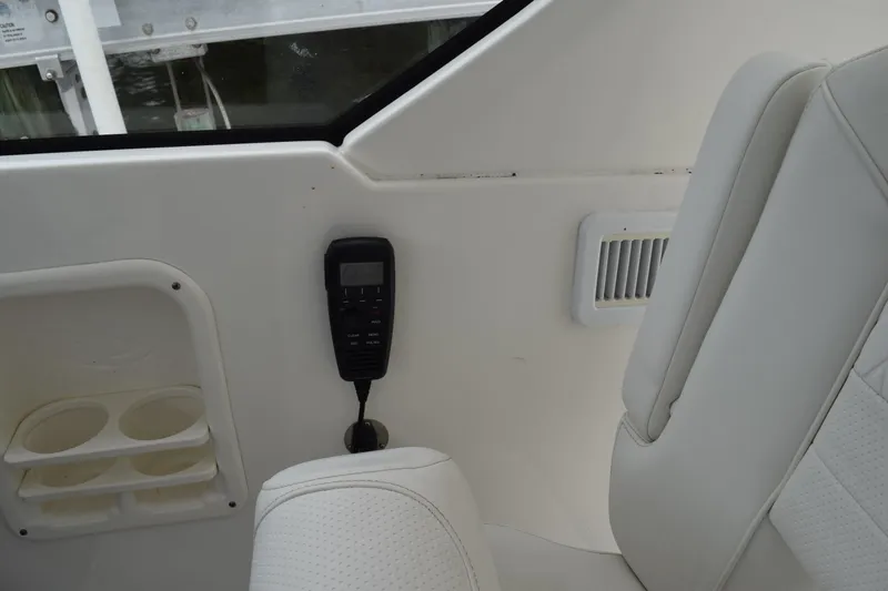 Slide: The Image of Interior of 2022 Pursuit OS 355 Offshore boat with white seating and control panel. - 258