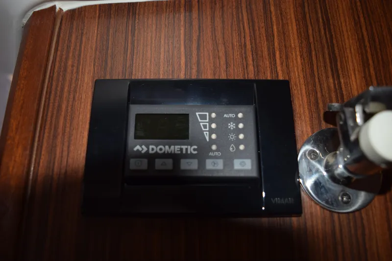 Slide: The Image of Dometic control panel on 2022 Pursuit OS 355 Offshore boat, mounted on wood panel. - 369
