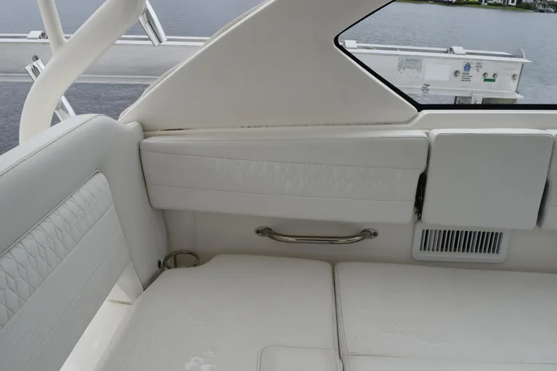 Slide: The Image of 2022 Pursuit OS 355 Offshore boat interior with white seating and stainless steel handle. - 232