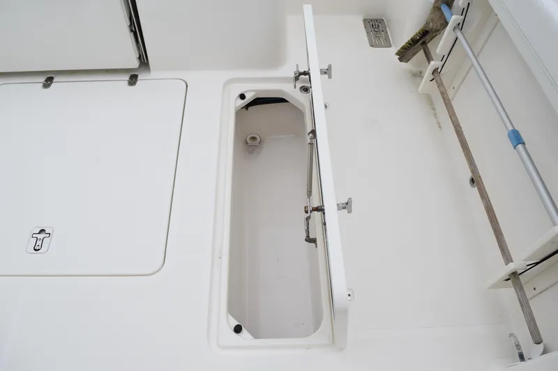 Slide: The Image of 2022 Pursuit OS 355 Offshore boat storage compartment with open hatch. - 123