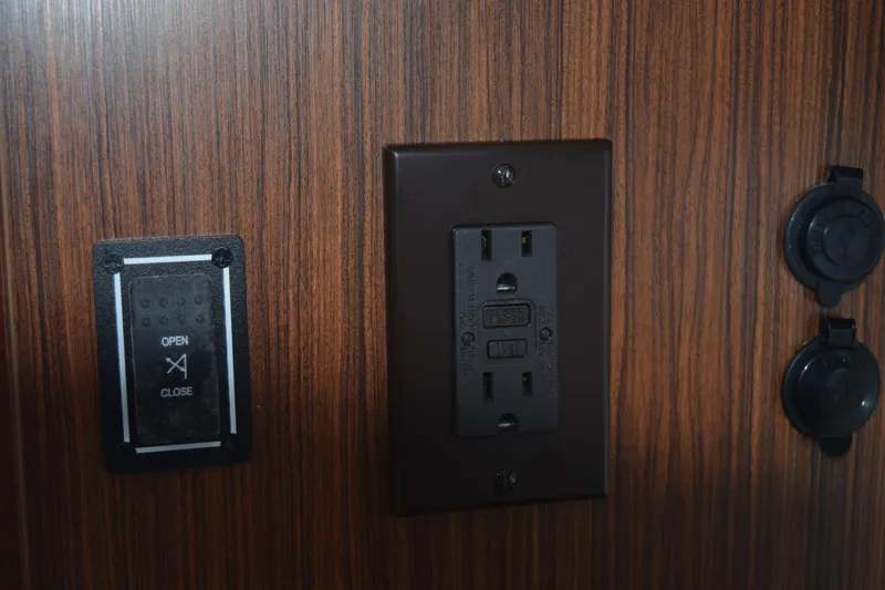 Slide: The Image of Control panel and outlet on 2022 Pursuit OS 355 Offshore boat interior. - 441